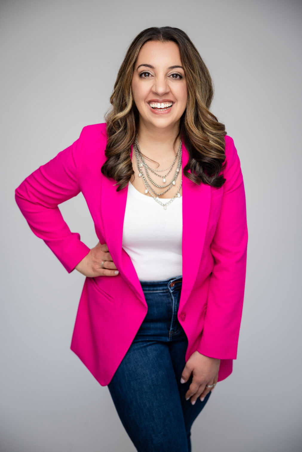 headshot of a woman in a pink blazer
