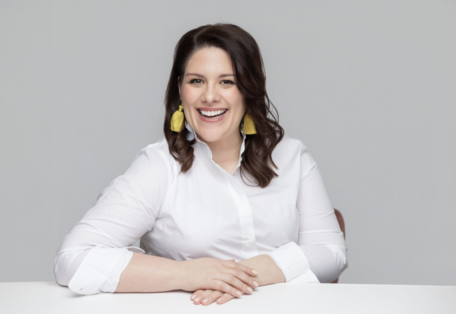 Professional headshot with bright, modern lighting and a confident, approachable expression.