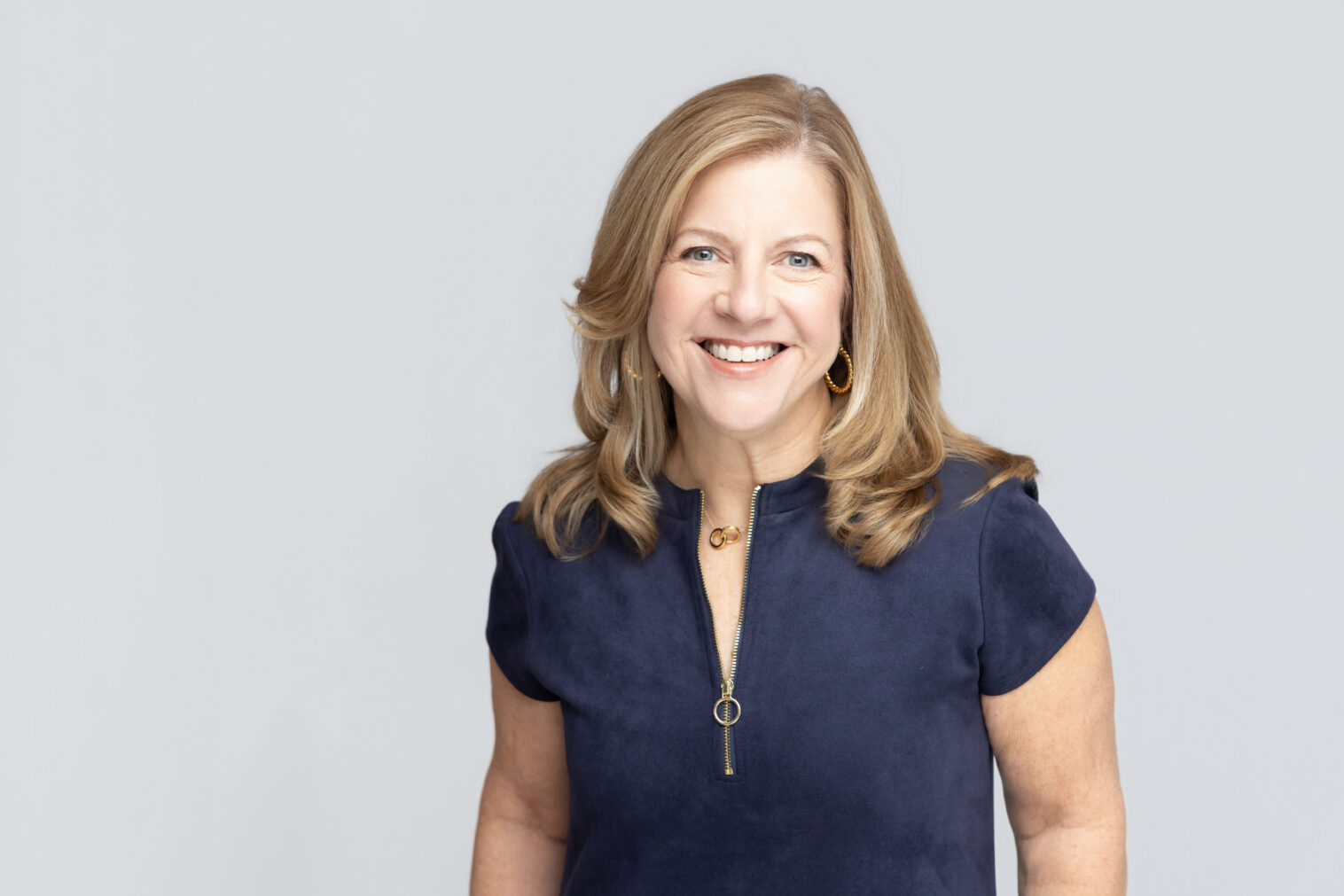 Professional headshot with bright, modern lighting and a confident, approachable expression