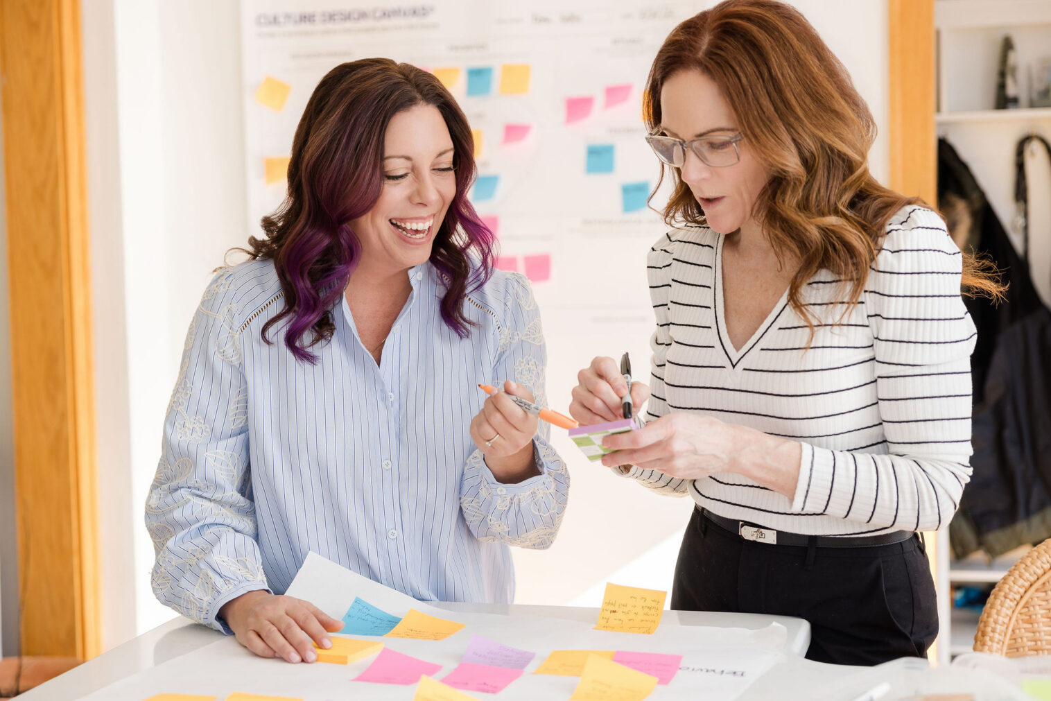 Woman entrepreneur during personal branding photography session in Barrington IL, styled in professional outfit with props reflecting her business